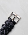 Original white gold Piaget buckle fitted to a black leather strap.