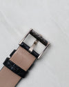 Reverse view of the Piaget signed white gold buckle on a black leather strap.