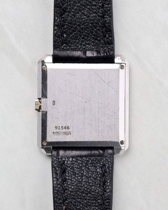 Caseback view of the Piaget Protocole Ref. 91546 in 18k white gold with reference engraving and light wear visible.