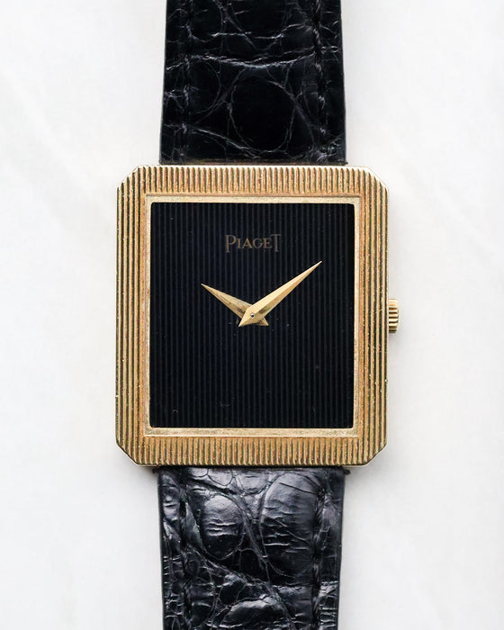 Piaget Protocole Ref. 8154 with black onyx tapestry dial and ribbed 18k yellow gold case photographed from the front.