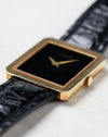 Side profile of the Piaget Protocole Ref. 8154 showing its ultra-thin 18k yellow gold case and crown.