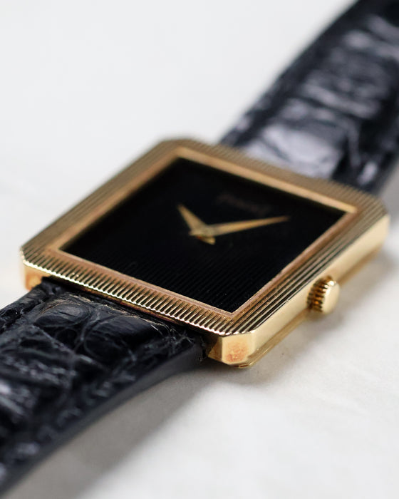 Side profile of the Piaget Protocole Ref. 8154 showing its ultra-thin 18k yellow gold case and crown.