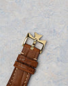 Original yellow gold Vacheron Constantin Maltese cross buckle attached to a brown leather strap.
