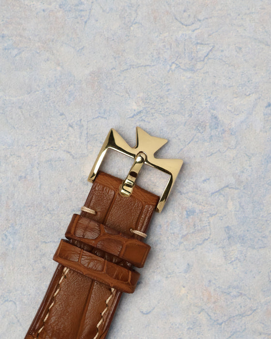 Original yellow gold Vacheron Constantin Maltese cross buckle attached to a brown leather strap.