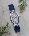 Front view of the Cartier Baignoire Biplan ref. 2295 with silver guilloché dial, Roman numerals and blued hands.