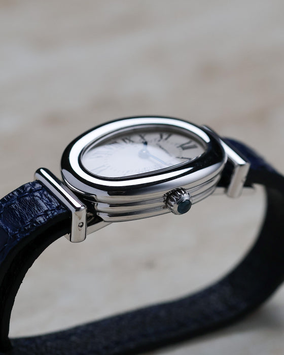 Cartier Baignoire Biplan ref. 2295 viewed from the crown side showing the cabochon-set crown and stepped case profile.