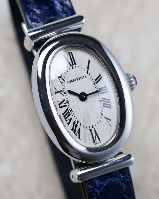 Close-up of the Cartier Baignoire Biplan ref. 2295 displaying the oval dial and polished white gold case.