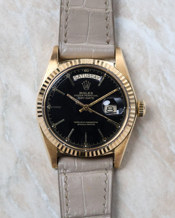 Front view of the Rolex Day-Date 1803 with black lacquer dial, yellow gold case and day-date display.