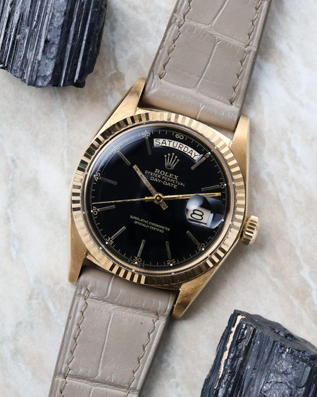 Angled view of the Rolex Day-Date 1803 highlighting the black lacquer dial and fluted bezel.