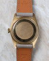 Caseback view of the Rolex Day-Date 1803 in yellow gold fitted to a grey leather strap.