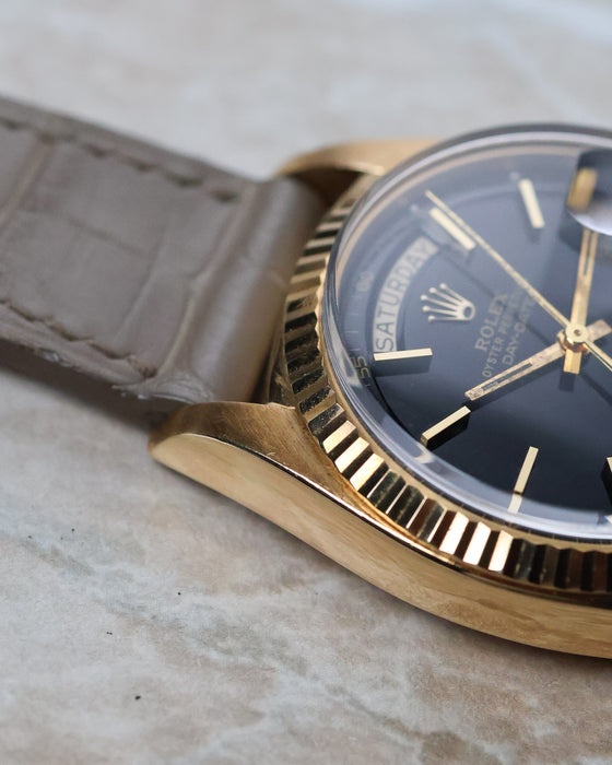 Macro detail of the Rolex Day-Date 1803 lug and fluted bezel in yellow gold.