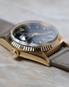 Side profile of the Rolex Day-Date 1803 showing the signed crown and sharp lug profile.
