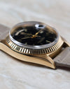 Angled dial view of the Rolex Day-Date 1803 with black lacquer dial and applied baton markers.