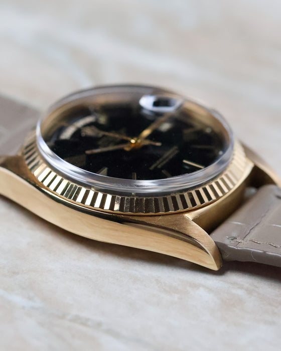 Angled dial view of the Rolex Day-Date 1803 with black lacquer dial and applied baton markers.