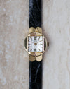 Patek Philippe Ref. 3017 yellow gold ladies watch with white dial photographed from directly above.