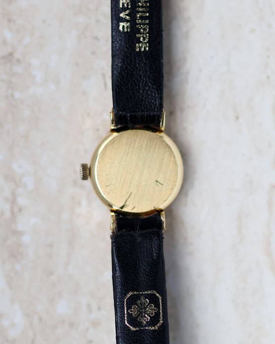 Patek Philippe Ref. 3017 yellow gold ladies watch showing the brushed caseback and signed strap.