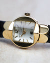 Patek Philippe Ref. 3017 yellow gold ladies watch showing the pagoda crystal and white dial from an angled front view.