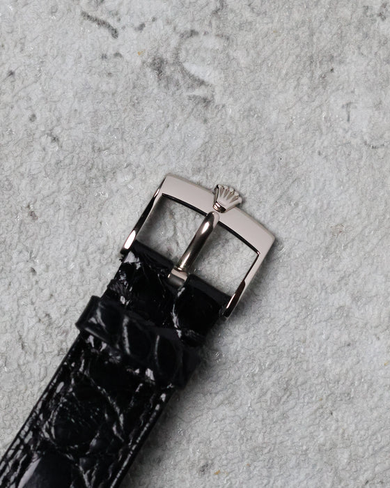 Original 18K white gold Rolex tang buckle fitted to the black leather strap.