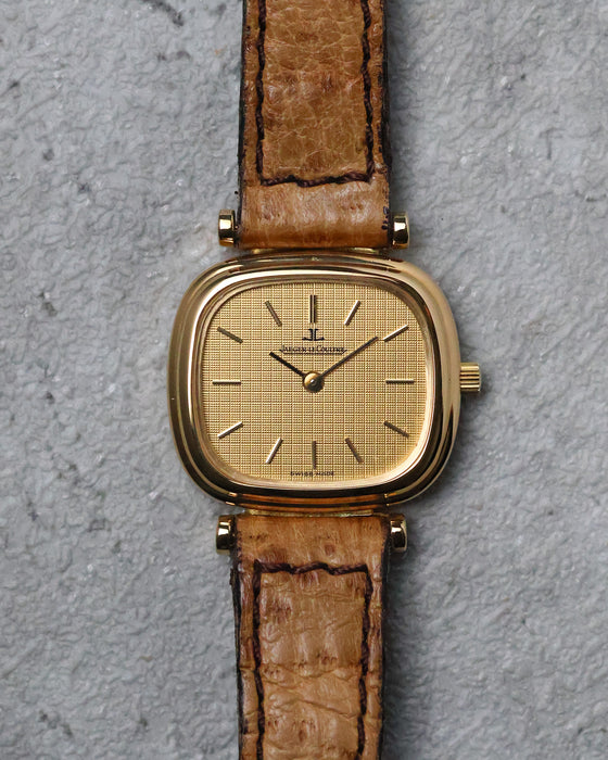 Jaeger-LeCoultre Ref. 6143.31 in 18K yellow gold with textured gold dial and brown leather strap.