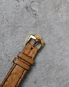 JLC-signed gold-plated pin buckle fitted to the brown leather strap.
