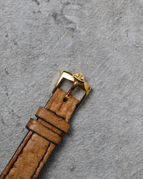 JLC-signed gold-plated pin buckle fitted to the brown leather strap.