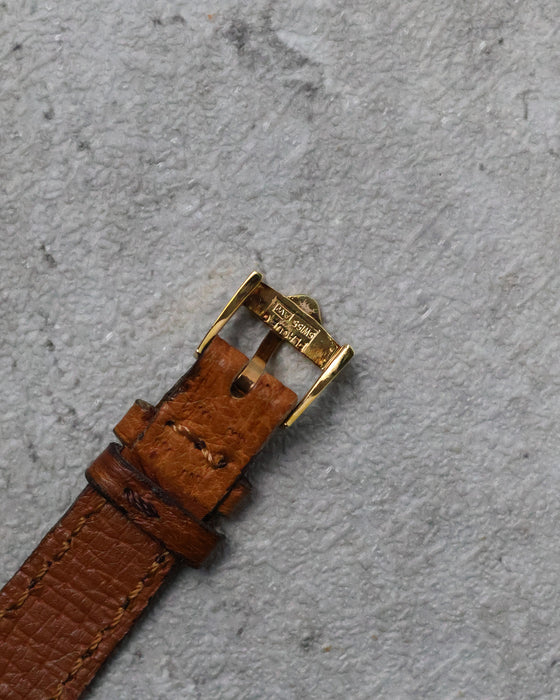 Reverse of the signed buckle showing its plated construction and Swiss markings.