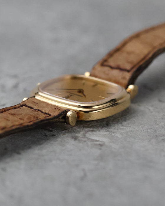 Angled side view showing the polished bezel and unusual articulated lug construction.
