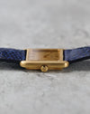 Crown-side profile highlighting the rounded brushed gold case and signed Girard-Perregaux crown.