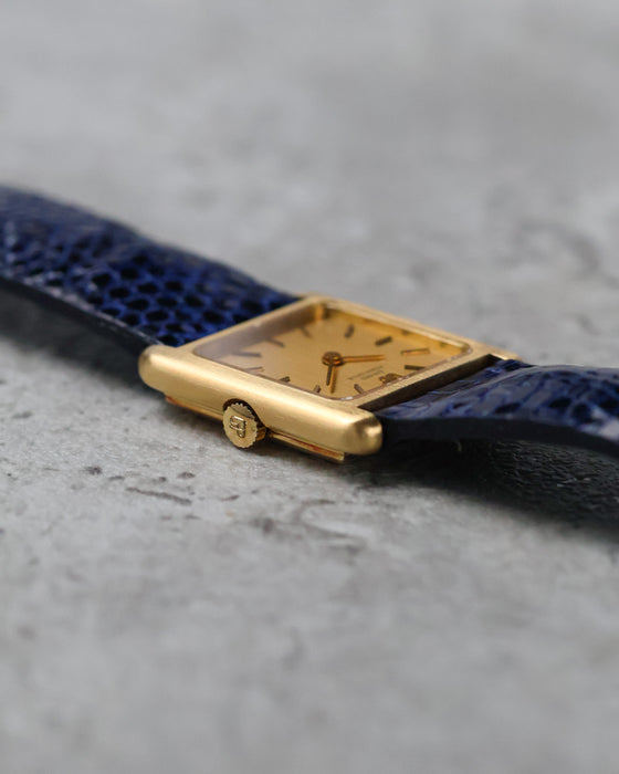 Angled view of the Girard-Perregaux showing its gilt dial, applied baton indexes and rectangular case.