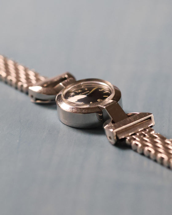 Side profile showing the domed crystal, stainless steel case and articulated lug construction.