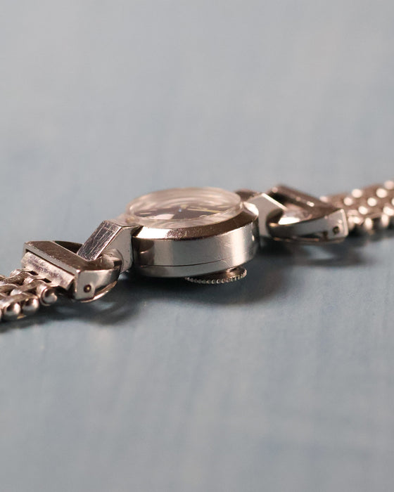 Side view of the Jaeger-LeCoultre back-wind watch showing the rear crown positioned beneath the case.