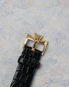 Original yellow gold Vacheron Constantin buckle attached to the black leather strap.