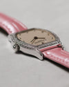 Low-angle profile highlighting the slender white gold case, sculpted lugs and the way the diamond setting wraps around the bezel.