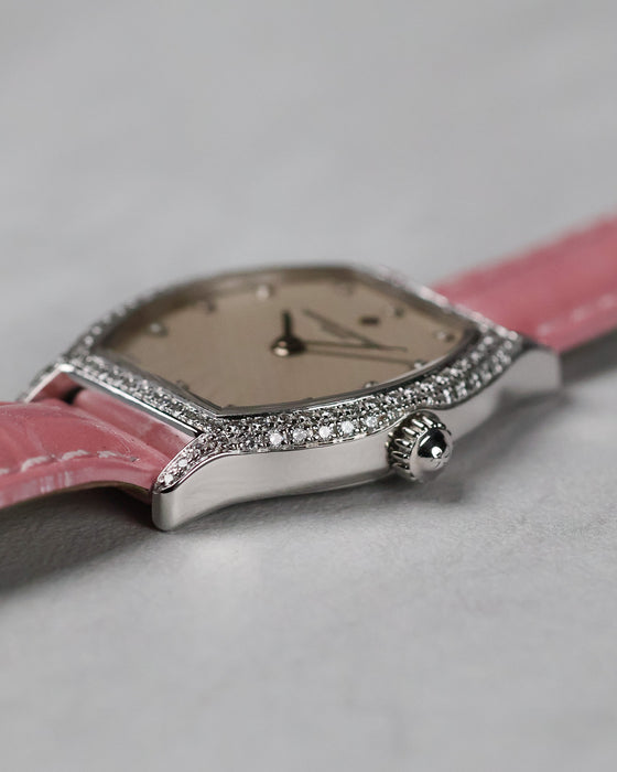 Crown-side view highlighting the flowing tonneau case and diamond setting.