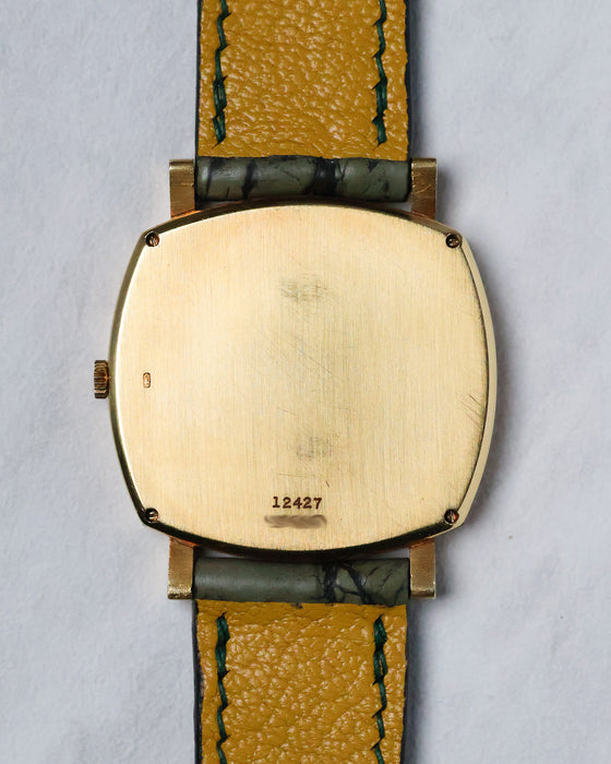 Caseback of the Piaget Reference 12427 showing the brushed 18k yellow gold back and hallmarks.