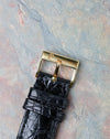Original Piaget signed 18k yellow gold pin buckle fitted to the black leather strap.