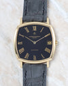 Front view of the Vacheron Constantin Ref. 7390 with a black dial, 18K yellow gold cushion case, and Roman numerals.