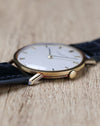 Angled view of Vacheron Constantin Ref. 7811 showing its crown, polished case and white dial.