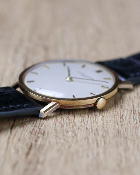 Angled view of Vacheron Constantin Ref. 7811 showing its crown, polished case and white dial.