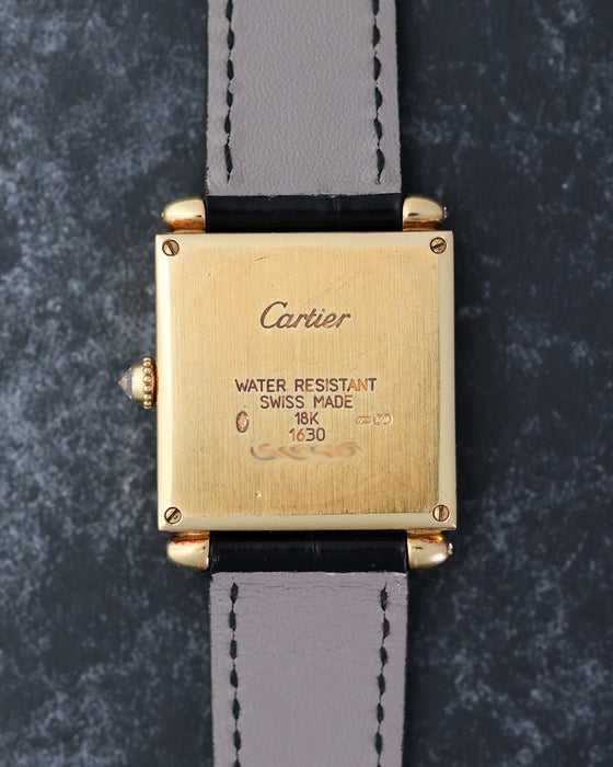 Caseback of the Cartier Tank Obus Ref. 1630 showing the 18K gold case and hallmarks.
