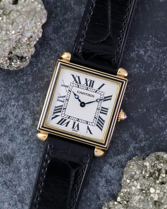 Angled front view of the Cartier Tank Obus Ref. 1630 highlighting the black enamel bezel and square case.