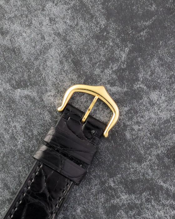 Original Cartier 18K yellow gold pin buckle fitted to the black leather strap.