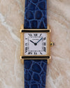 Front view of the Cartier Tank Chinoise Ref. 81051 in 18K yellow gold showing the white lacquer dial and blue leather strap.
