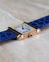 Side profile of the Cartier Tank Chinoise Ref. 81051 showing the brushed case, polished brancards and sapphire cabochon crown.