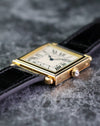 Low side profile of the Cartier Tank Obus Ref. 1630 showing the stepped case and diamond cabochon crown.