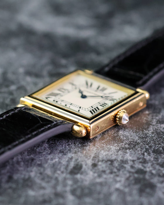 Low side profile of the Cartier Tank Obus Ref. 1630 showing the stepped case and diamond cabochon crown.