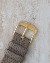 Original gold-tone Universal Genève signed buckle paired with the leather strap.
