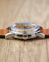 Front side profile of the Omega Seamaster Calendar Ref. 2849 showing the signed crown, polished case and domed acrylic crystal.