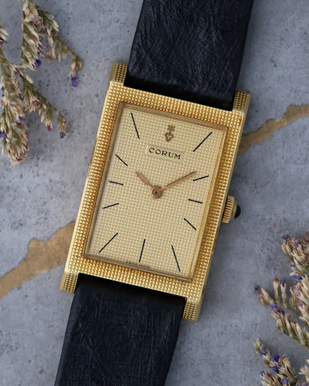Angled front view highlighting the textured dial and hobnail finished case.