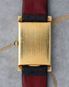 Rear view showing the solid 18K yellow gold case back.